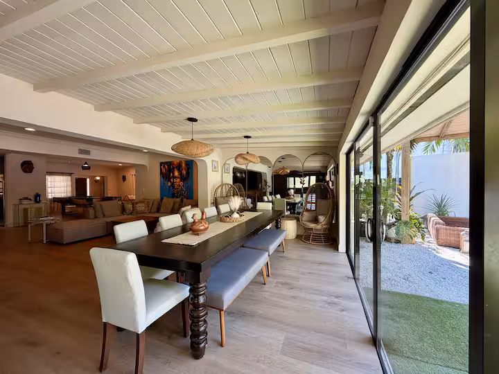 The long dining table opening onto the patio