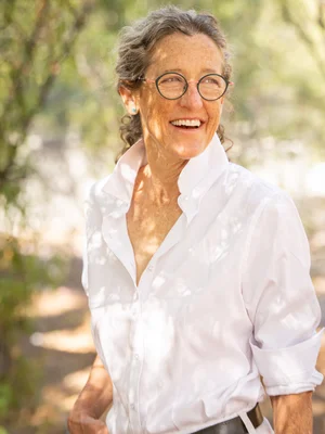 Outdoor portrait of a smiling woman in a white shirt